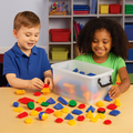 Two children playing with colorful building blocks in a classroom setting.
