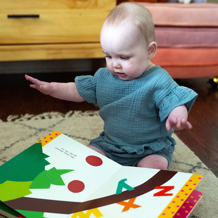 Toddler with Chicka Chicka Boom book