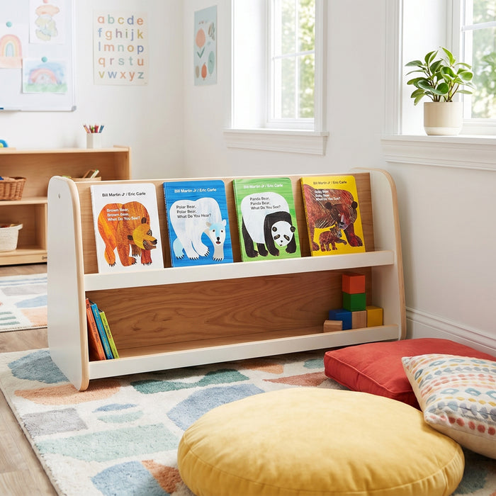 Children's bookshelf with colorful books in a bright room with toys and cushions.