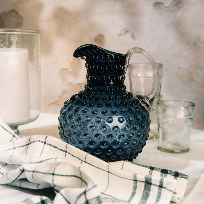 Hobnail Glass Pitcher in Atlantic Blue on a table at Addison West