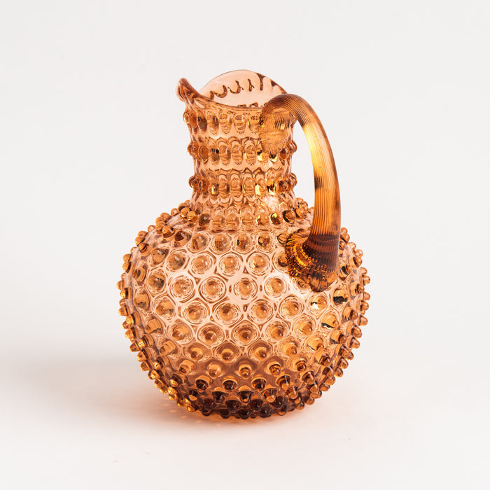 Hobnail Glass Pitcher in Honey Gold on a white background at Addison West
