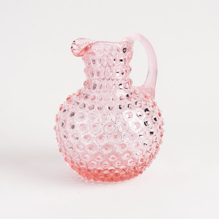 Hobnail Glass Pitcher in Petal Pink on a white background at Addison West