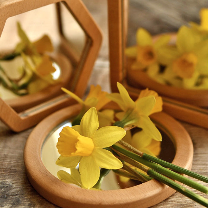 Three Shaped Mirrors Reflecting Flowers
