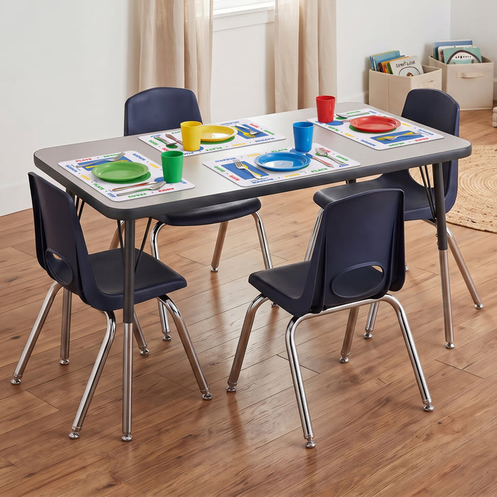 A children's dining table set with a gray rectangular table and four navy blue chairs with chrome legs, styled with colorful placemats, plates, and cups on a wood floor.