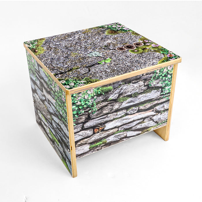 Cube-shaped bench with a natural wood and stone pattern on a white background