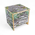 Cube-shaped bench with nature-themed design on a white background