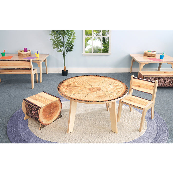 Wooden children's table and chairs set in a classroom setting with a rug and plant.
