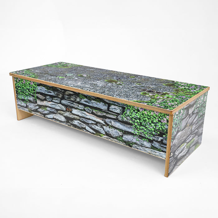 Bench with stone and greenery design on a white background