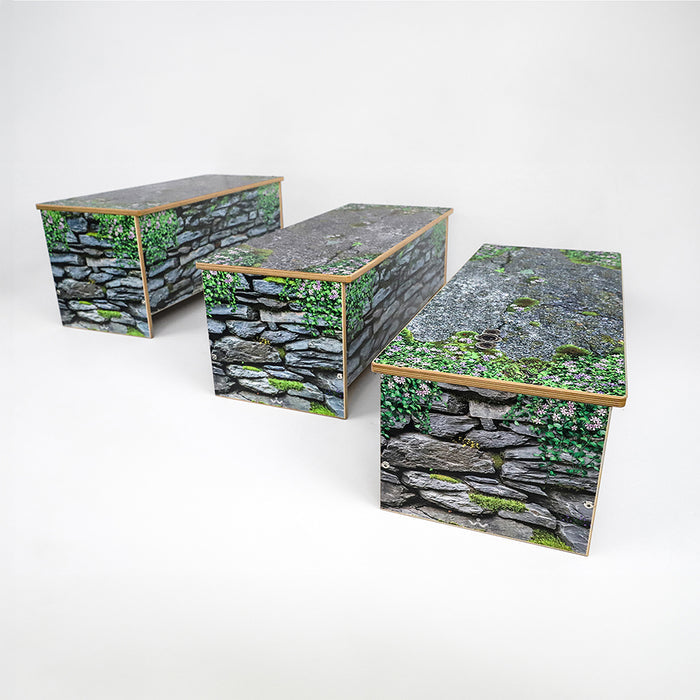 Three wooden benches with stone and greenery design on a white background