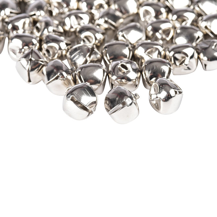 close-up of pile of nickel plated jingle bells on white background