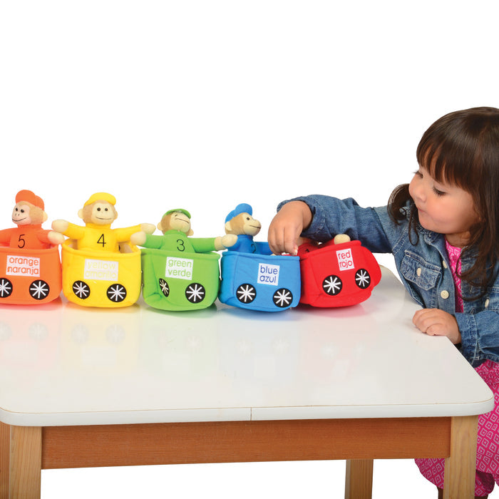 Child playing with colorful toy cars on a table