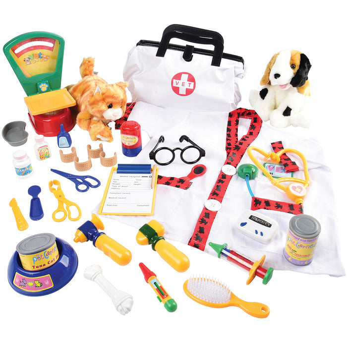 A collection of toy vet equipment and accessories laid out on a white background, including a stethoscope, syringe, bandages, a pet scale, and plush toy animals.