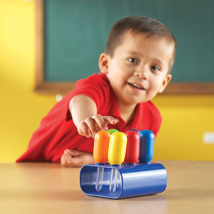 Child playing with a colorful toy in a classroom setting