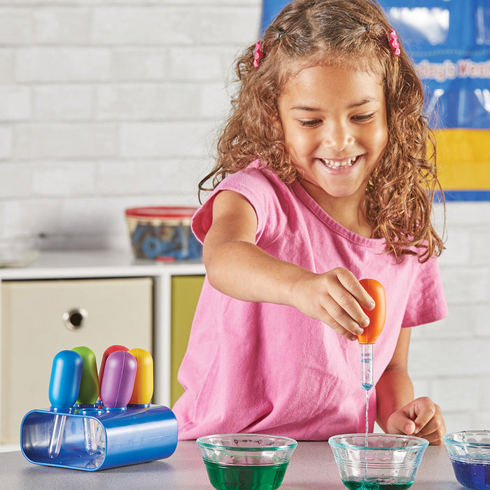 Child playing with colorful science experiment set in a kitchen setting