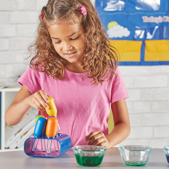 Young girl playing with colorful kitchen toys in a classroom setting