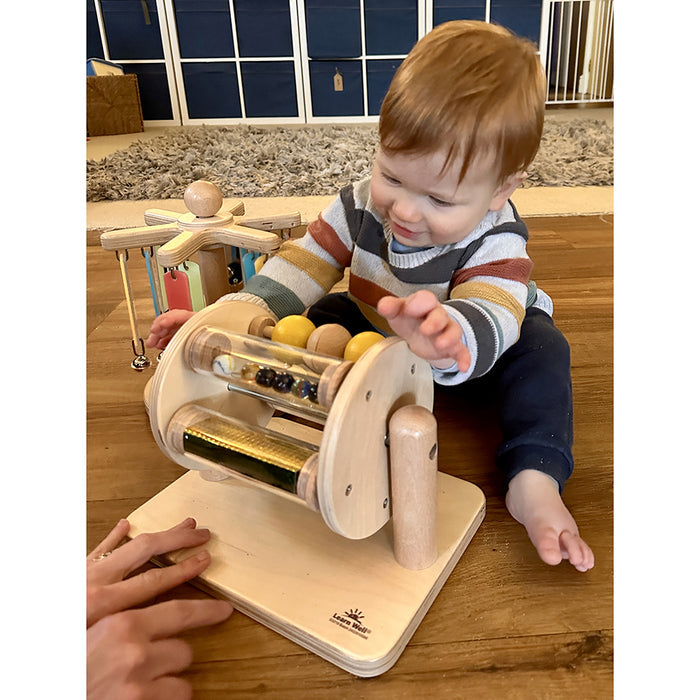 Toddler Playing with Sight & Sound Sensory Drum on Floor