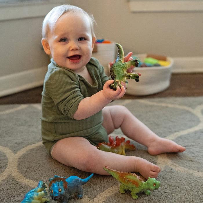 Toddler Engaging with Soft Squeezable Dinosaur Toys