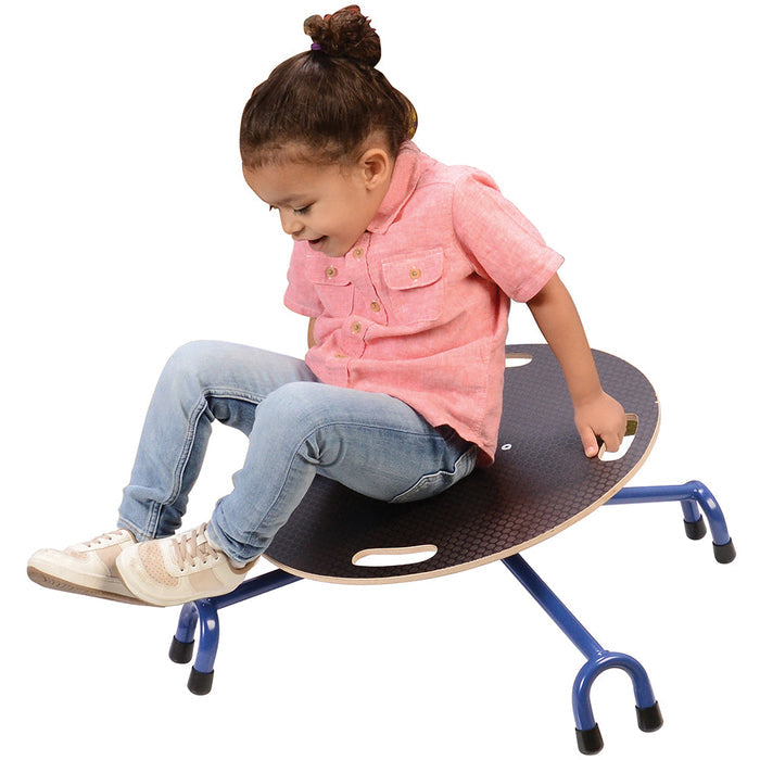 child in pink shirt on balance chair on white background