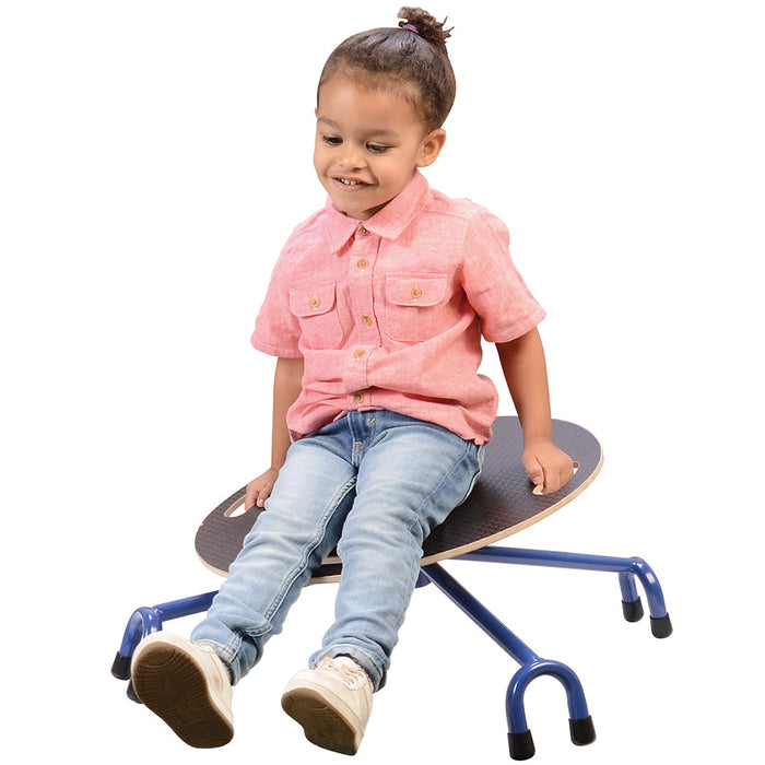 child in pink shirt sitting on balancing chair on white background