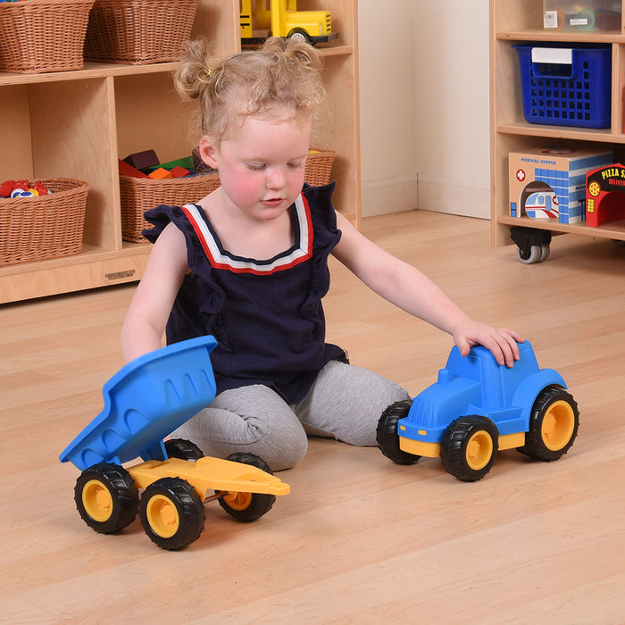 Child playing with Toy dump truck in classroom setting