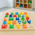 Colorful wooden alphabet puzzle on a wooden board with a blurred background of children's toys.